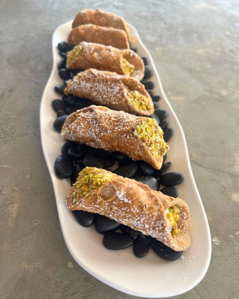 Pistachio filled cannolis on modern serving platter at Dolce & Gabbana event