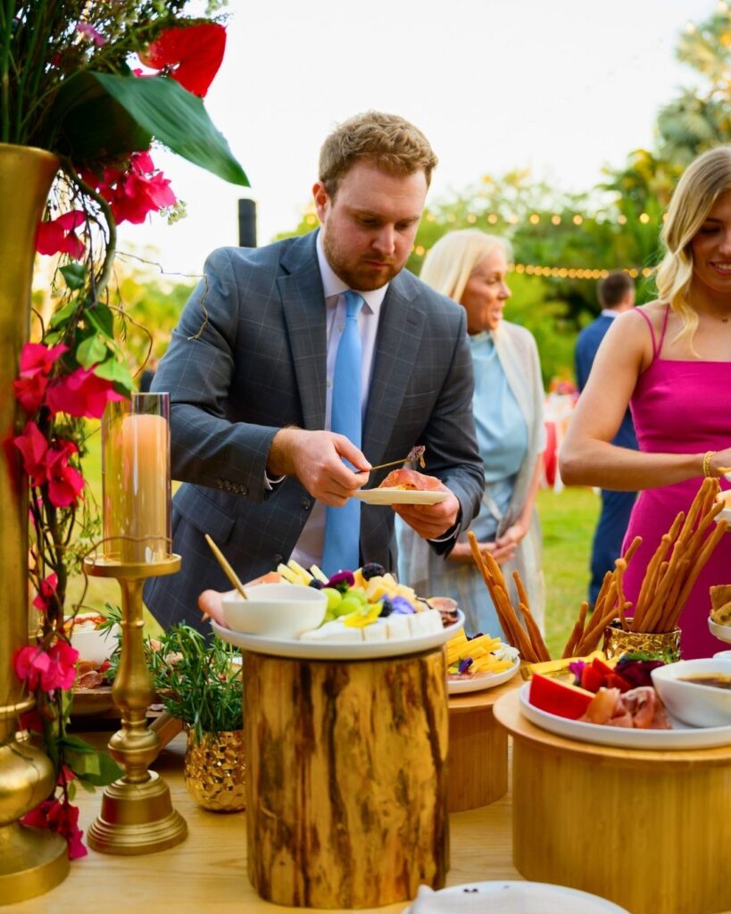 Guest enjoying charcuterie at a tropical wedding reception.