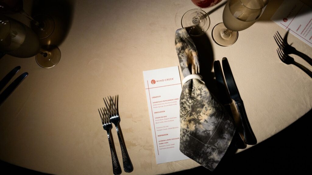 Close-up of elegant menu and marble napkin at Wind Creek corporate dinner