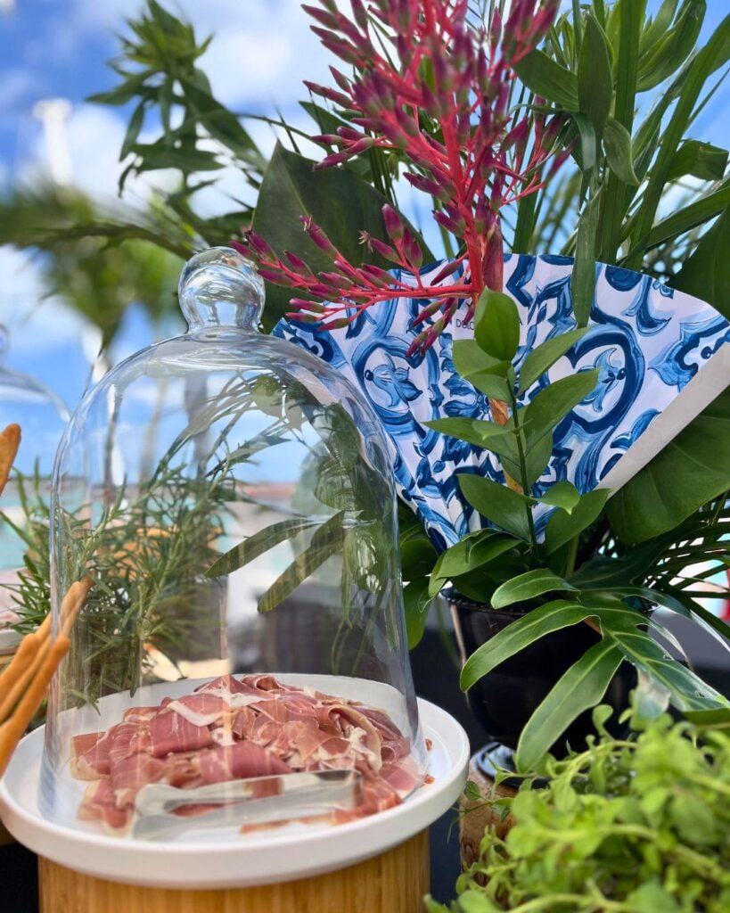 Prosciutto antipasto under glass cloche at Dolce & Gabbana display