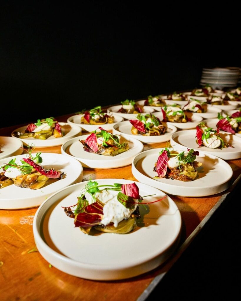 Multiple plates of composed salad ready for service