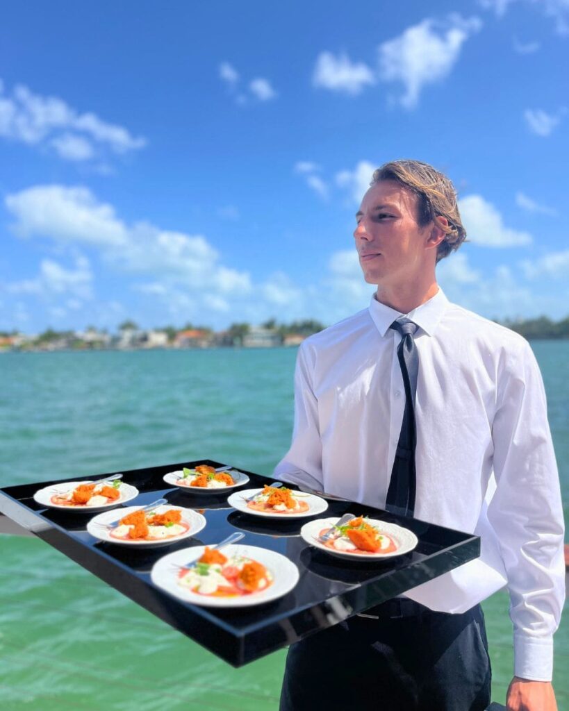Server presenting tomato appetizers at Dolce & Gabbana yacht event