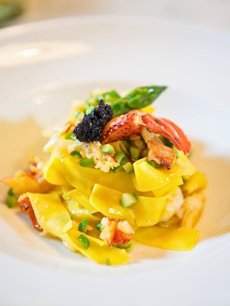 Luxury lobster pasta topped with black caviar at a catered event in Miami.