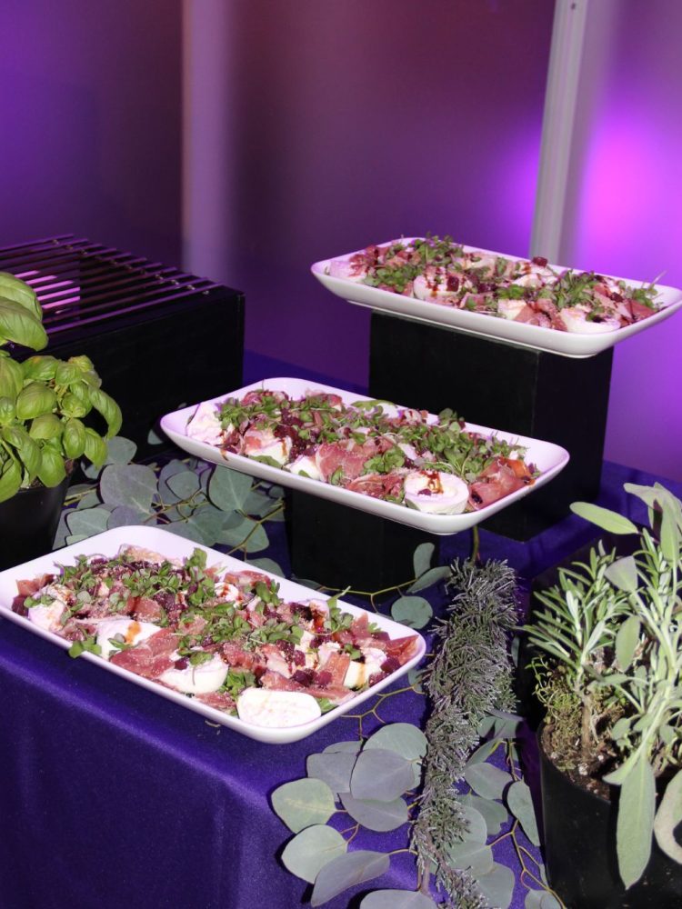 Buffet display with salad platters and fresh herbs.